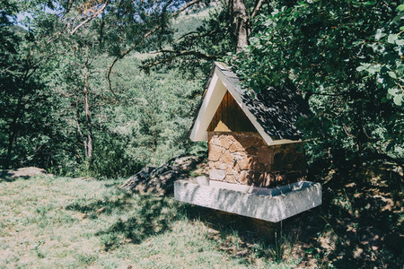 A house shaped fountain in the middle of a hiking trail in a forest in Catalonia  Spain