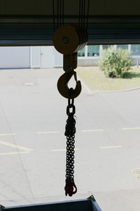 Cable winch hook with chains at loading dock doorway
