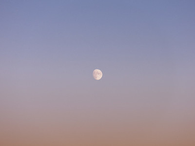 Near full moon in tranquil dusk sky
