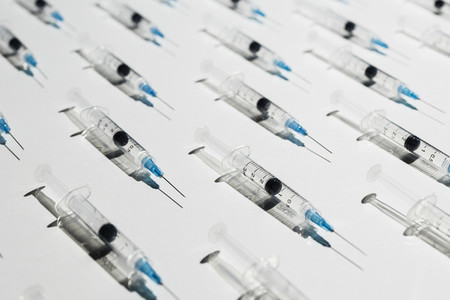 COVID 19 vaccine syringes on white background