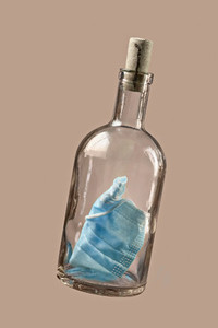 Disposable protective face mask in corked bottle