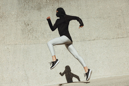 Woman in sportswear running outdoors