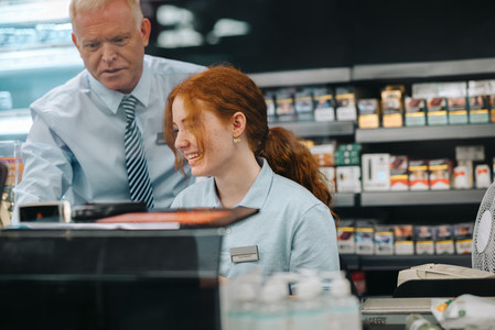 Trainee cashier with store manager