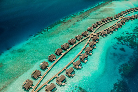 Aerial view of overwater villas at a luxury island