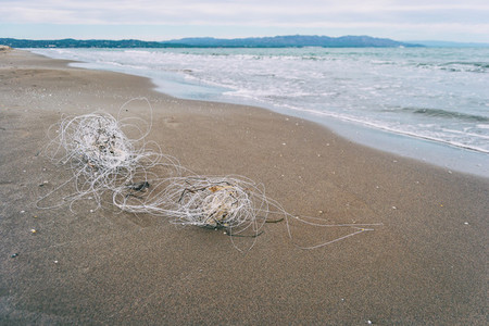 plastic string washed up on a beach