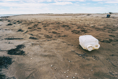 large plastic bottle washed up on a beach