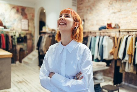 Fashion store owner smiling