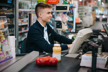 Man working at grocery store checkout