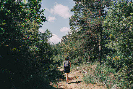 Girl walking along a small path in the mountain of Prades  Tarragona  Spain