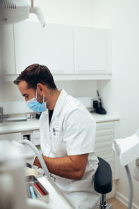 Dentist treating a patient at dentistry