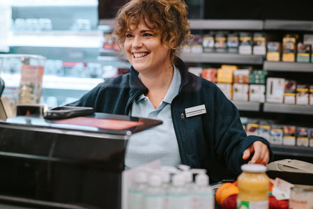 Cashier working at supermarket checkout