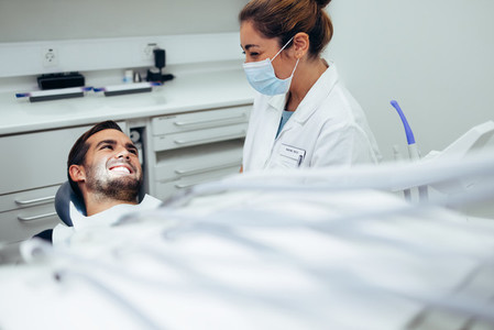 Dentist talking with male patient in dentistry