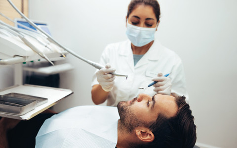 Man getting dental treatment in clinic
