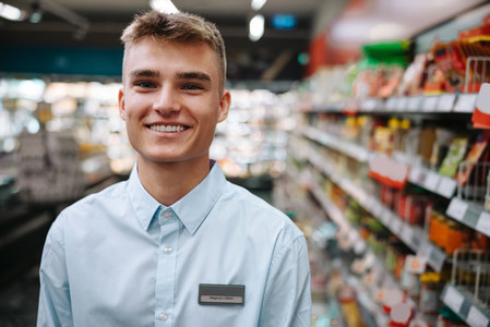 Happy young supermarket worker