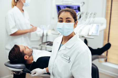 Dentists assistant with face mask