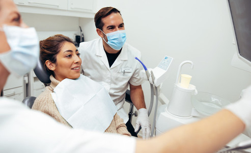 Dentists and patient looking at x ray image