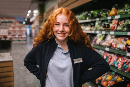 Grocery store worker smiling at camera