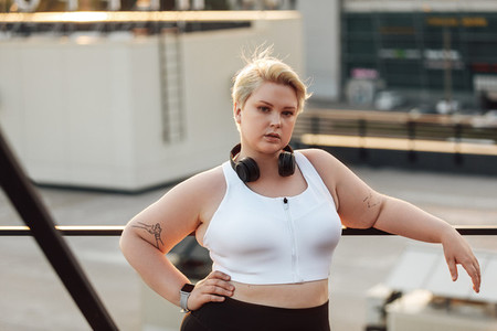 Portrait of a confident plus size woman standing on a roof