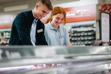 Trainee workers working together in supermarket