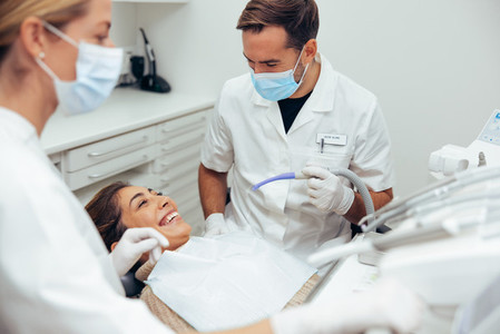 Woman smiling during her dental treatment