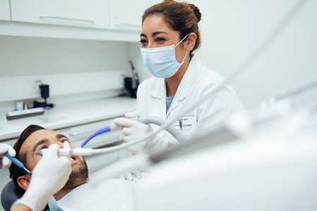 Dentist treating a patient in dental clinic