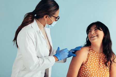 Happy female patient getting vaccine