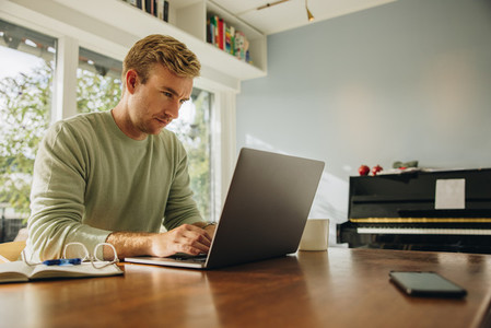 Man at home working on laptop
