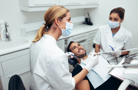 Dental doctor treating patient in clinic