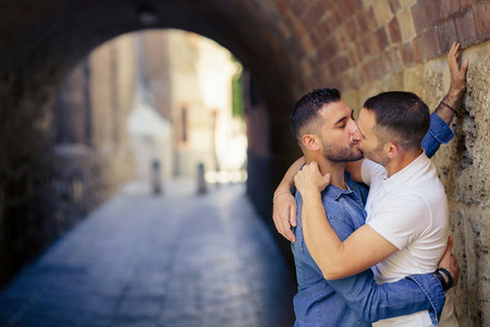 Gay couple kissing in a romantic moment outdoors