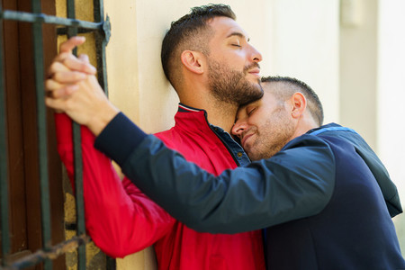 Gay couple hugging in a romantic moment outdoors