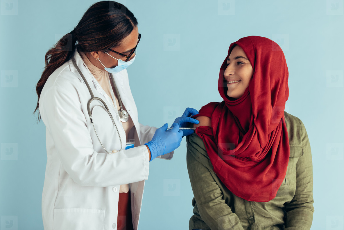 Muslim woman receiving vaccination