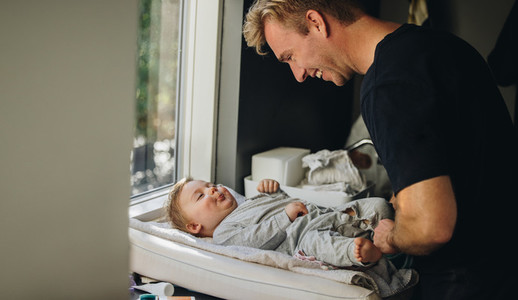 Caring father changing diaper