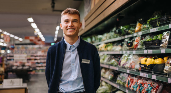 Portrait of young worker in supermarket
