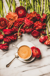 Cup of espresso coffee or cappuccino and ranunculus flowers