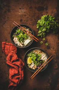 Vietnamese asian traditional rice noodle and chicken soup in bowls