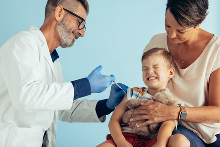 Doctor giving vaccine to a kid