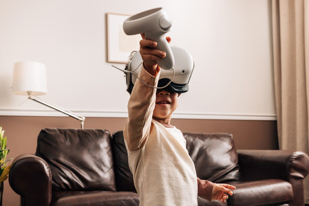 Kid playing virtual reality games at home  Little boy having fun with VR