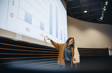 Female speaker giving presentation in a seminar
