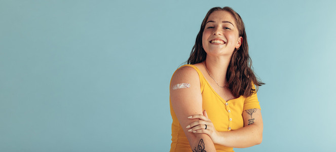 Beautiful woman looking happy after getting vaccine