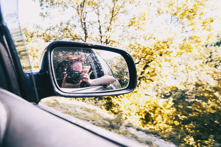 Selfie of a girl in the rear view of the car while the car is running