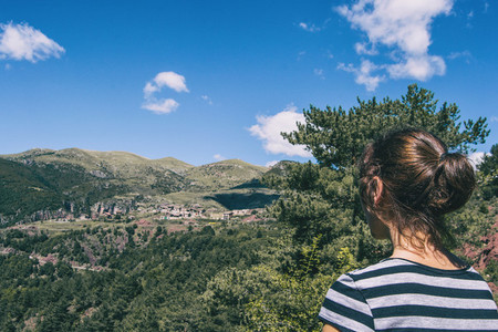 Girl walking along a small path in the mountain of Spain
