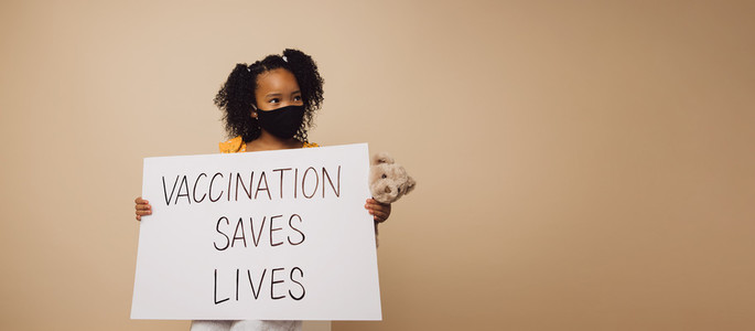 Girl holding Vaccination saves lives banner