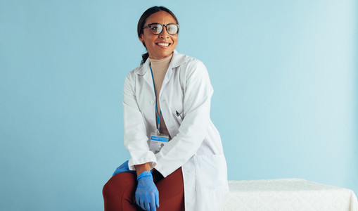 Smiling female doctor on blue background