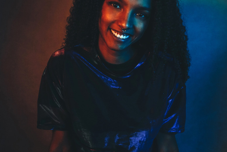 Artistic portrait with color lights of a young woman