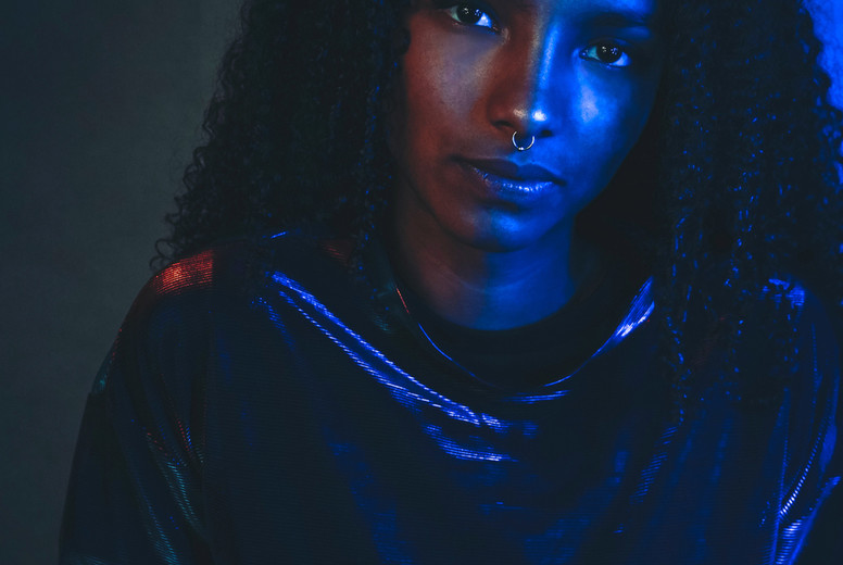 Artistic portrait with color lights of a young woman