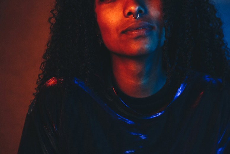 Artistic portrait with color lights of a young woman