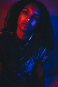 Artistic portrait with color lights of a young woman