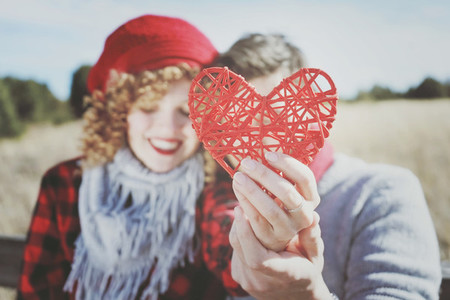 Lovely close up of a beautiful red heart held by a romantic youn