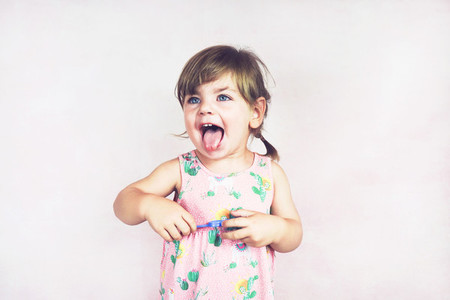 Young little and funny girl in a studio shot