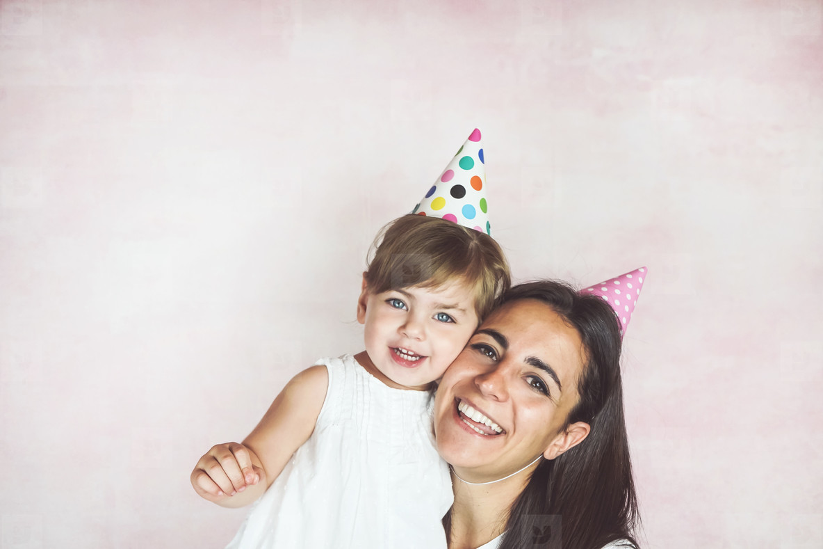 Happy mom and baby girl in a studio photoshoot